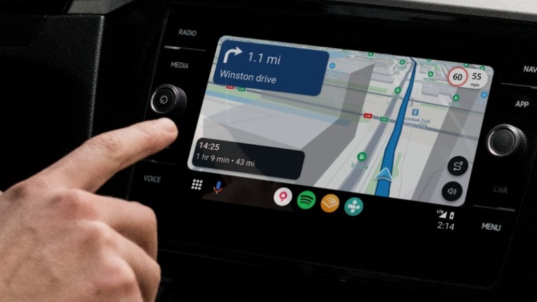 Close-up of a person interacting with the TomTom app on Android Auto