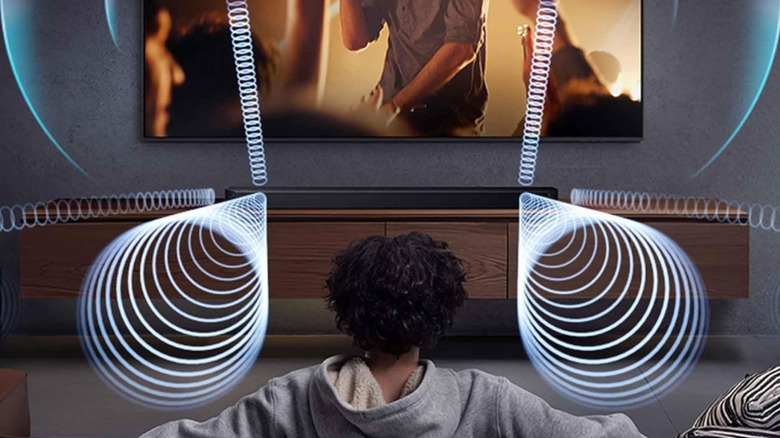 A person experiencing home theater immersion delivered via the Samsung HW-Q900F Soundbar.