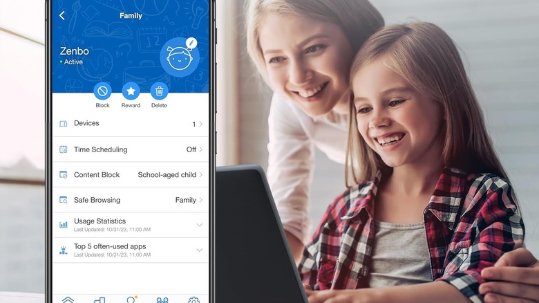 A mother and daughter use a laptop. A smartphone is opened to the Asus Router app.