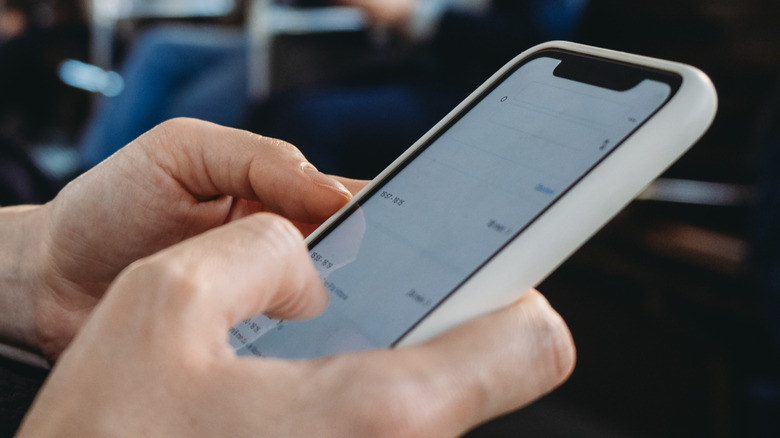 Close up of someone's hands touching a phone