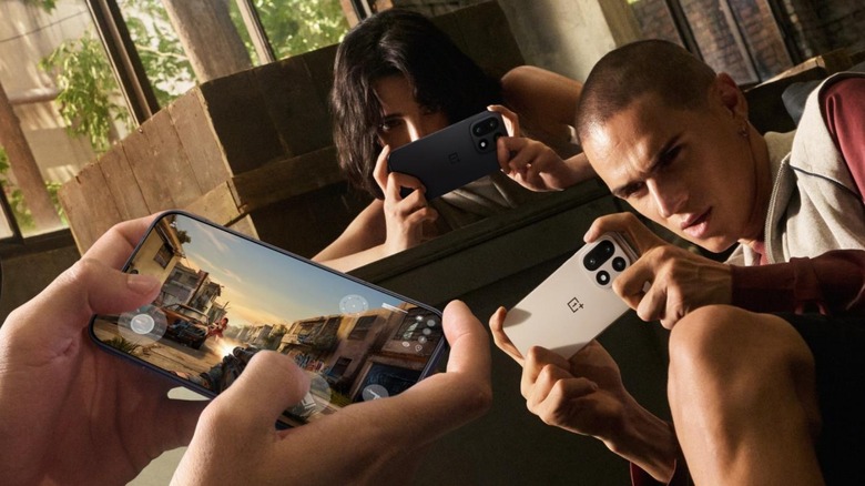 A group of people playing games on the OnePlus 15