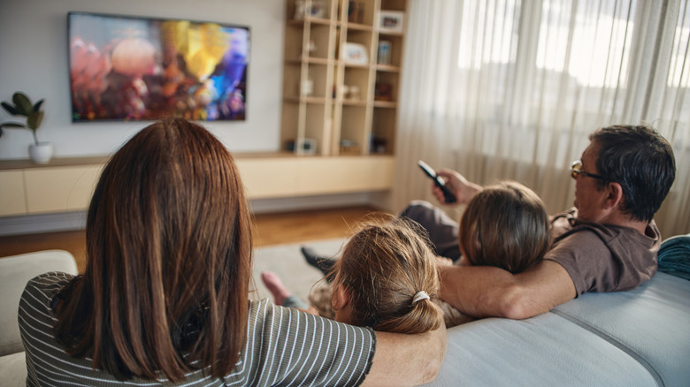 a family watching TV in the living room