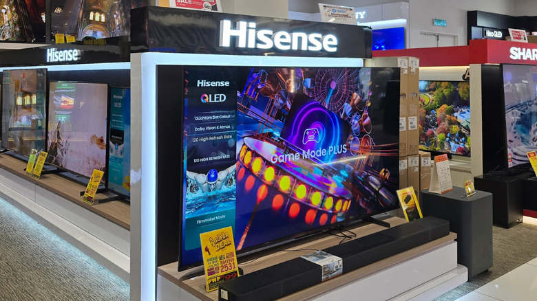 a Hisense TV on display at a store with Game Mode PLUS displayed