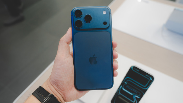 Blue iPhone 17 Pro Max in a user's hand