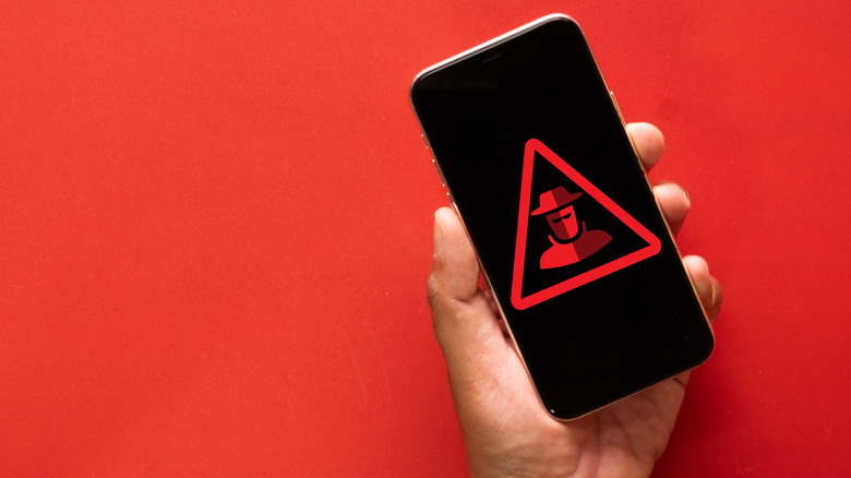 a smartphone with a cyber attack hacker symbol on it