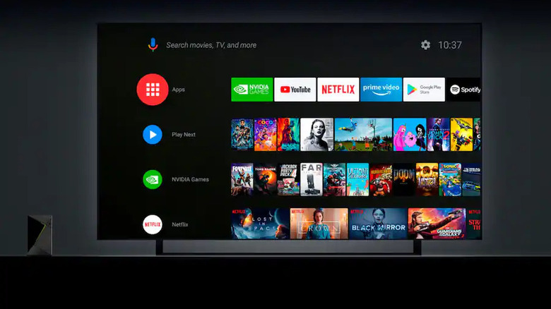 Shield TV Pro standing next to large screen TV showing small size alongside UI