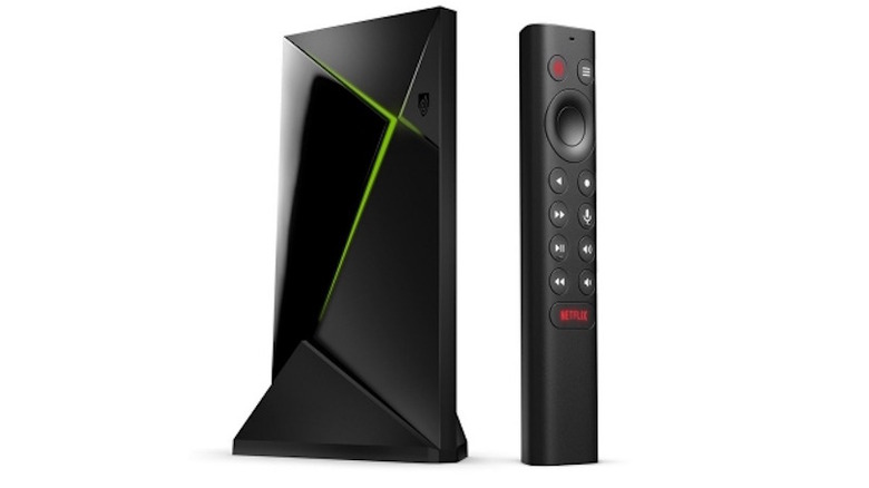 Shield TV Pro and remote against white background showing both lit up