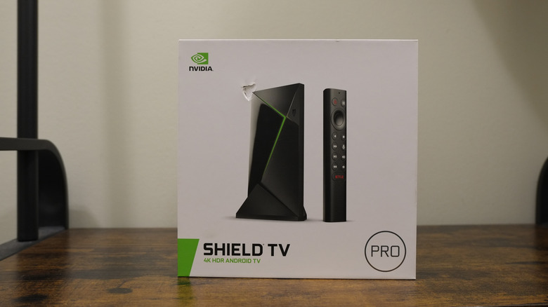 Nvidia Shield TV Pro device in its packaging on a wooden table