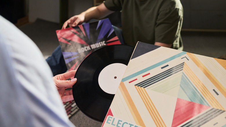 Two people handling vinyl records
