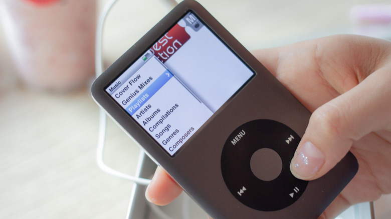A hand holding an iPod Classic.