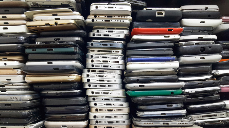 piles of old and broken smartphones