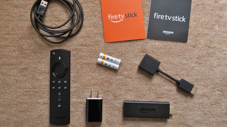 An Amazon Fire TV Stick and all its out-of-the-box accessories.