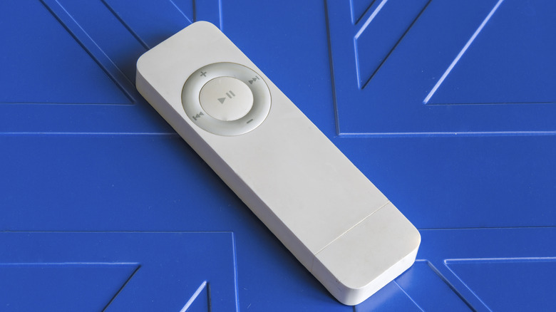 A 1st Generation iPod Shuffle on blue background