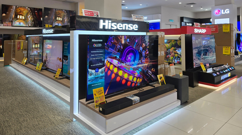 Hisense and Sharp QLED TVs on display in a store