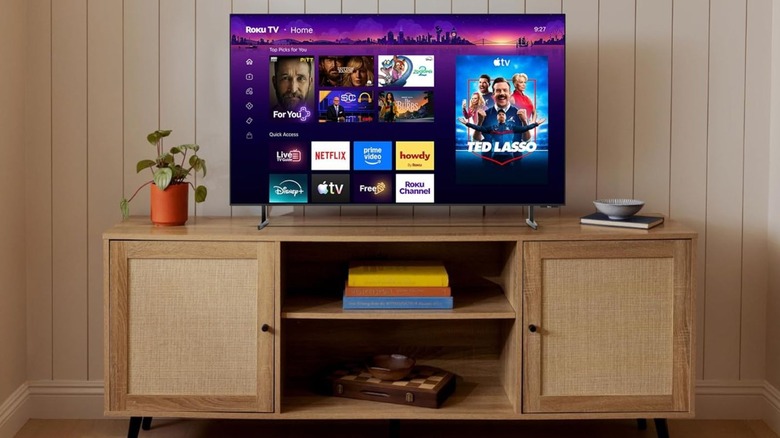 Roku TV sitting on entertainment center against wall