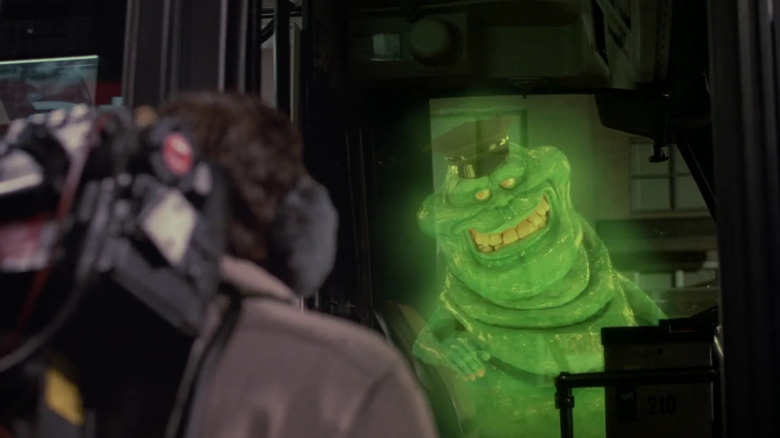 Slimer wearing a hat and driving the bus in Ghostbusters II