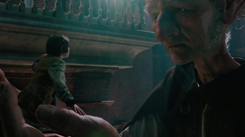 The Giant (Mark Rylance) holding Sophie (Ruby Barnhill) in "The BFG."