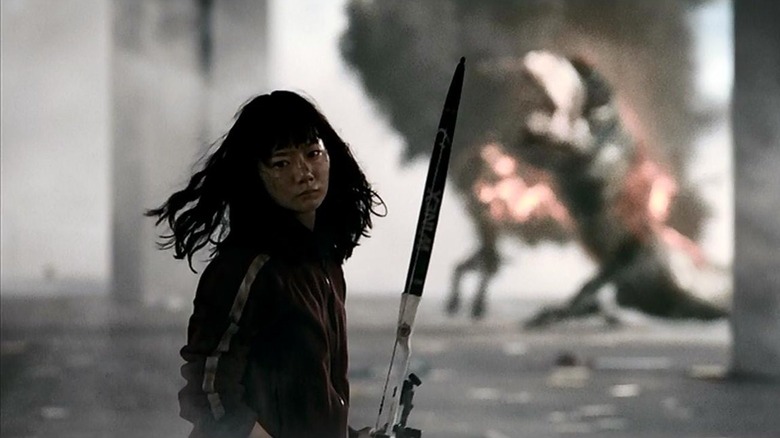 Nam-joo looking away after shooting the monster