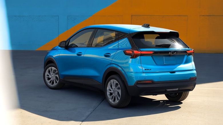 2027 Chevy Bolt rear of the vehicle visible while parked in a colorful lot.
