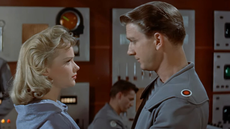 Commander Adams and Altaira stare lovingly on board a spaceship.