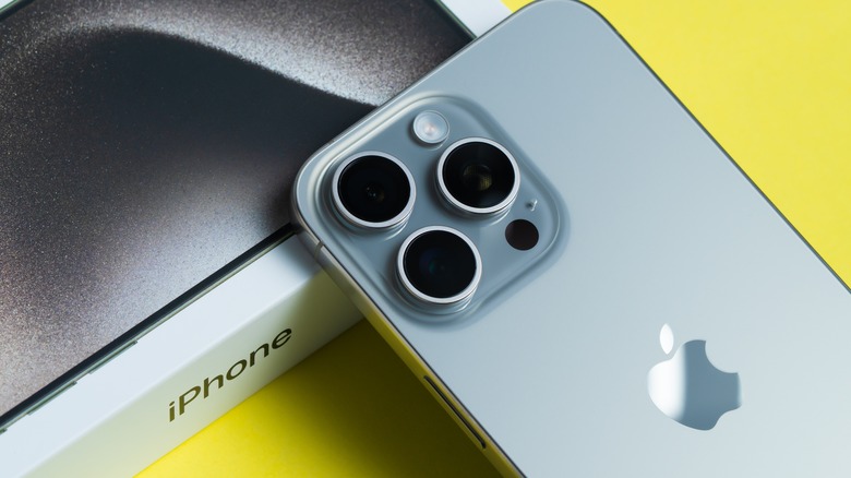 A close up of an iPhone resting against its product box.