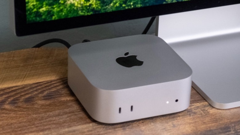 A Mac mini on a table connected to a Studio Display