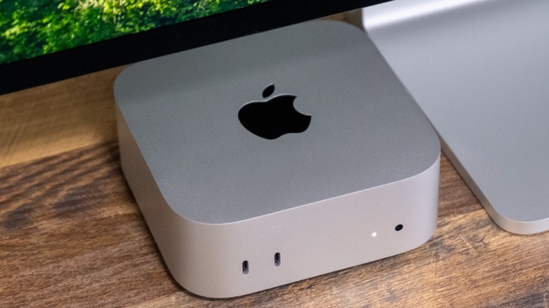 A Mac mini on a table connected to a Studio Display