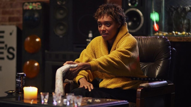 Mia holding the embalmed hand in 