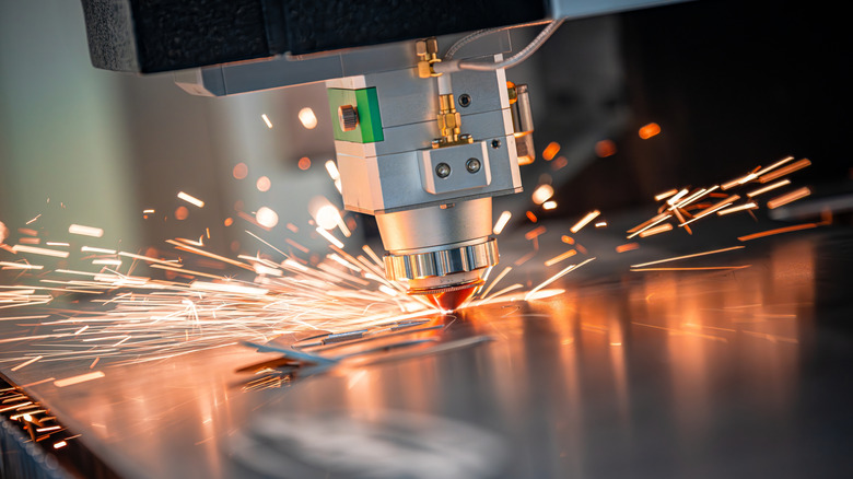 A machine cutting metal with sparks flying