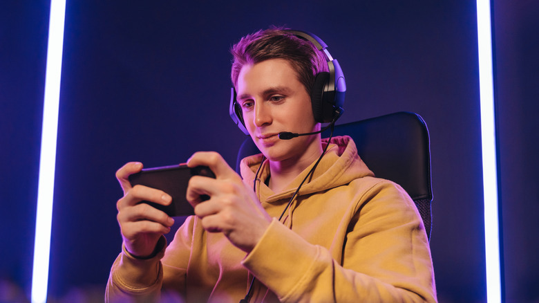 A person playing video games on a smartphone