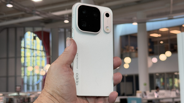 Person holding an Oppo Find X10 Pro Max showing rear panel and camera array