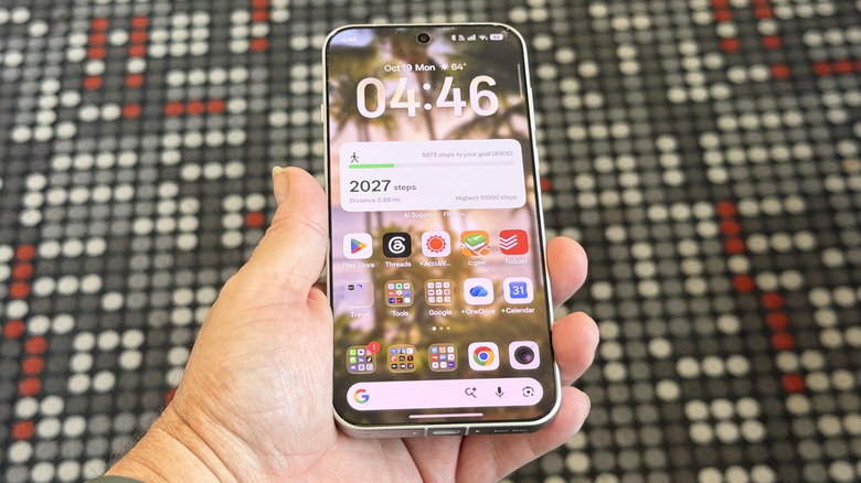 Person holding an Oppo Find X10 Pro Max showing home screen