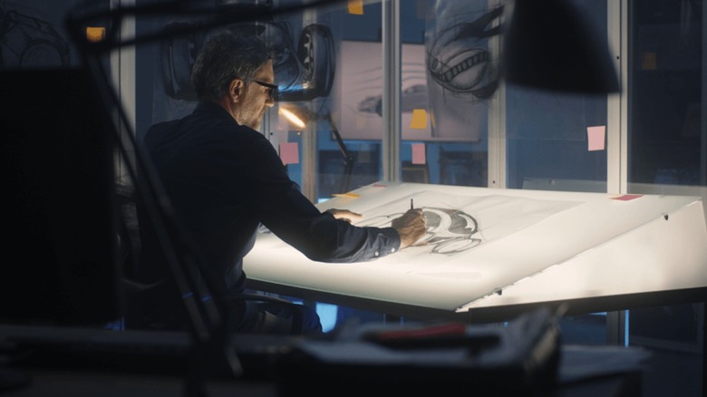 Man working at a lightbox table to create a custom design for Caviar