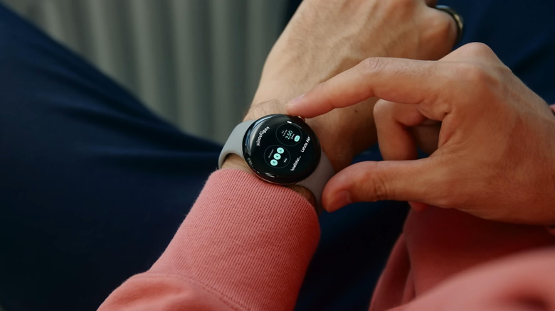 person's hands interacting with pixel watch on their wrist