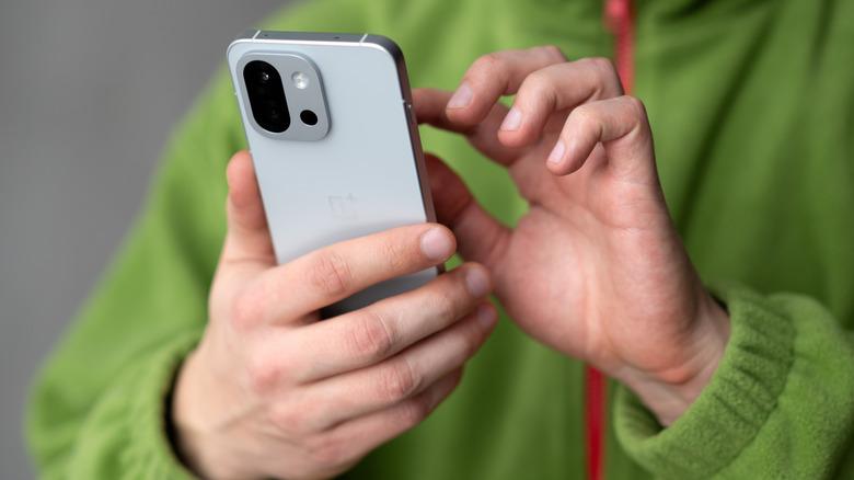 Person holding a OnePlus, Android smartphone.