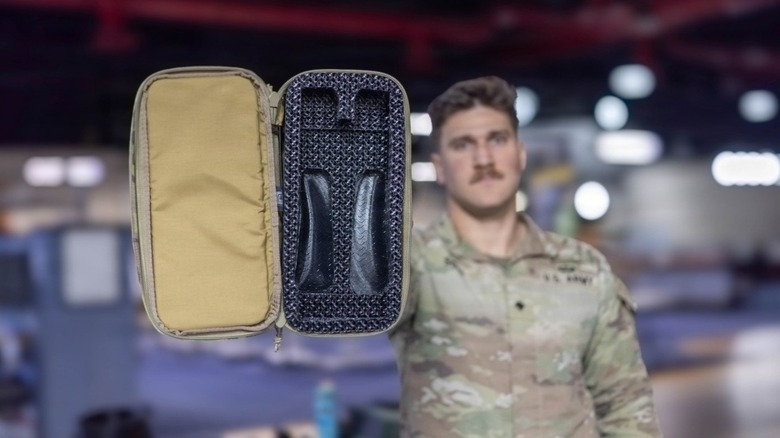 Soc. Alexander Soto holds up the Modular Drone Case, showcasing a futuristic interior capable of containing several types of UAVs.