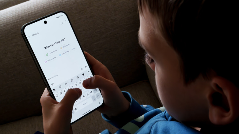 A child talking to ChatGPT on a phone.