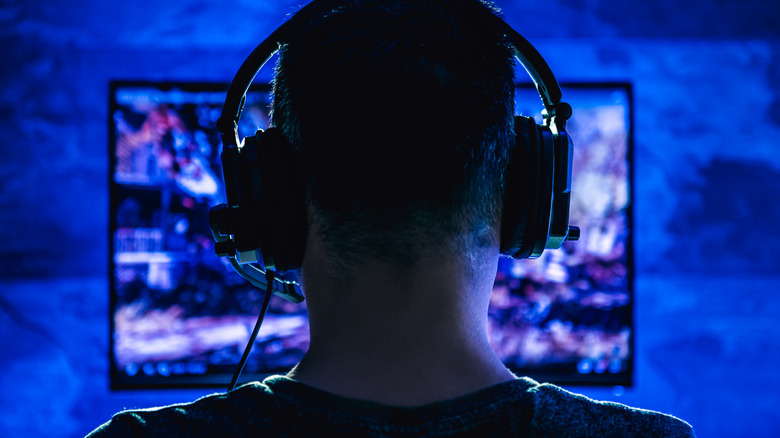 a man gaming on large PC monitor
