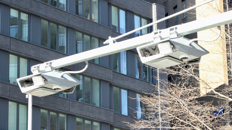 Close up of a toll collection system setup above a highway with cameras visible.