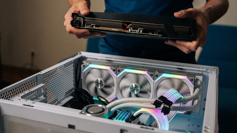 Person installs new component in gaming PC