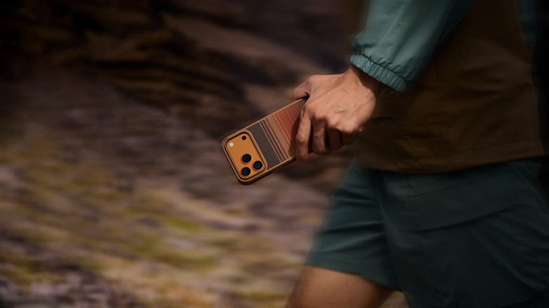 PITAKA's iPhone 17 Ridge Series Aramid ProGuard Case being held by a man walking