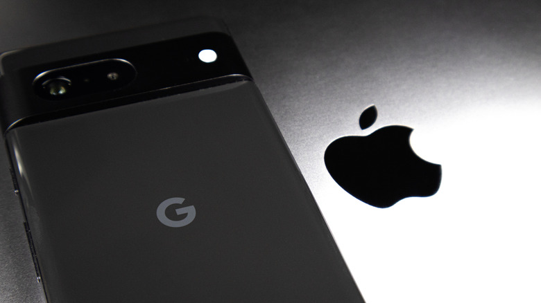 The Google and Apple logos seen on a Pixel phone and a laptop, respectively.