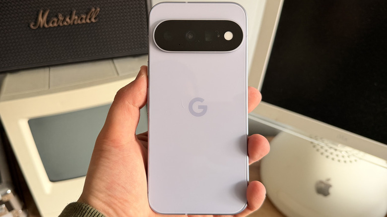 The Pixel 11 in hand with the rear camera bar visible