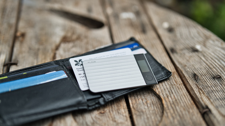 Plaud Note Pro laid of top of a wallet showing the diminutive size