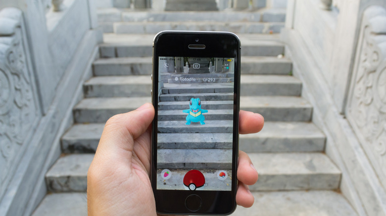 someone playing pokemon go on a set of stairs