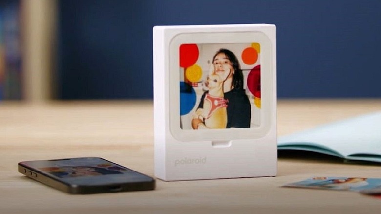 Polaroid Hi-Print 3by3 instant printer used as a frame on tabletop.