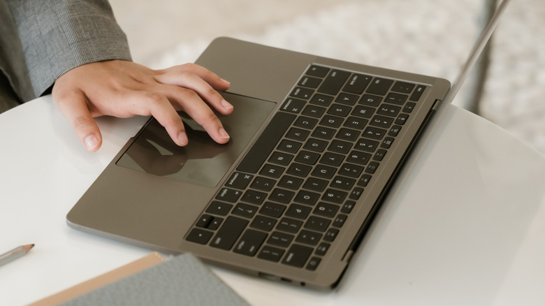 A person using a laptop in an office