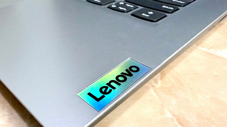 A close-up of the Lenovo logo on a laptop