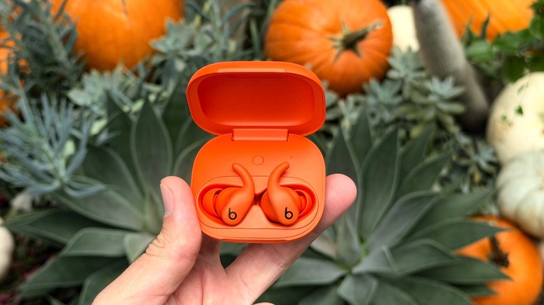 Powerbeats Fit in Spark Orange with pumpkins in the background