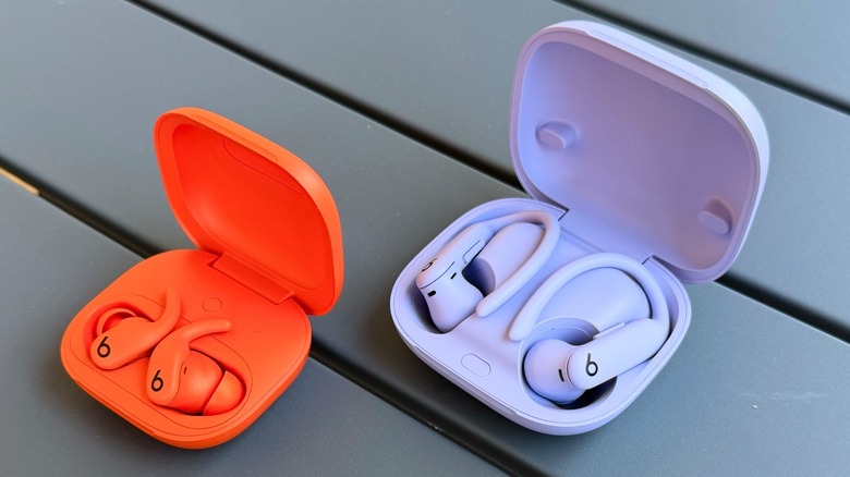 Powerbeats Fit and Powerbeats Pro 2 earbuds inside their charging cases